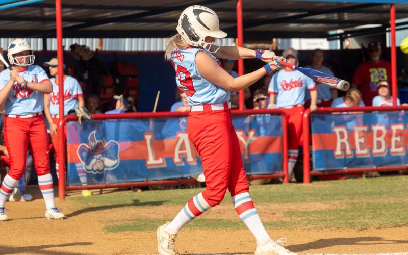Lady Rebel Trinity Ford swings at the ball.