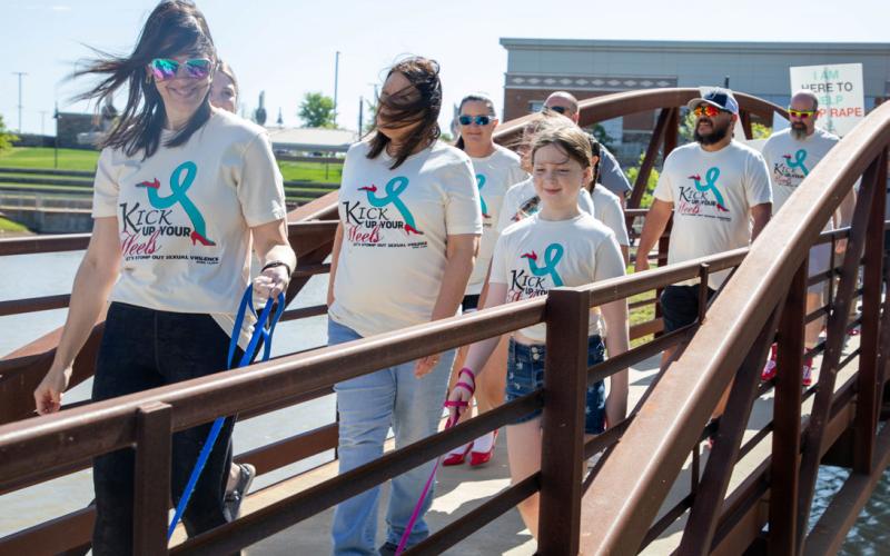 Choctaw Nation Family Violence Director Anna Marcy, left, walks in the Kick up Your Heels Sexual Assault Awareness Walk Saturday at the Choctaw Nation Headquarters. Also shown is her daughter, Danica Marcy, right.