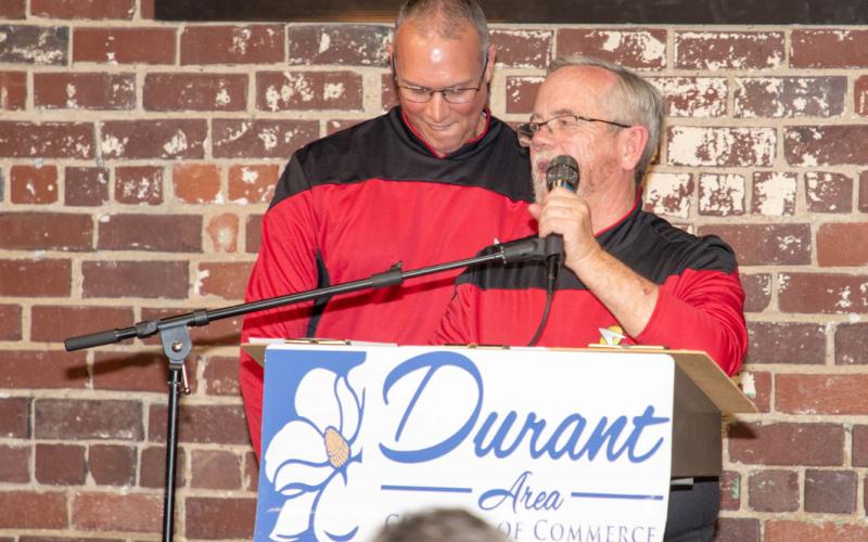 Incoming Chamber President Rob Piearcy, left, and outgoing Chamber President Scott Dewald speak at the chamber banquet last Friday.