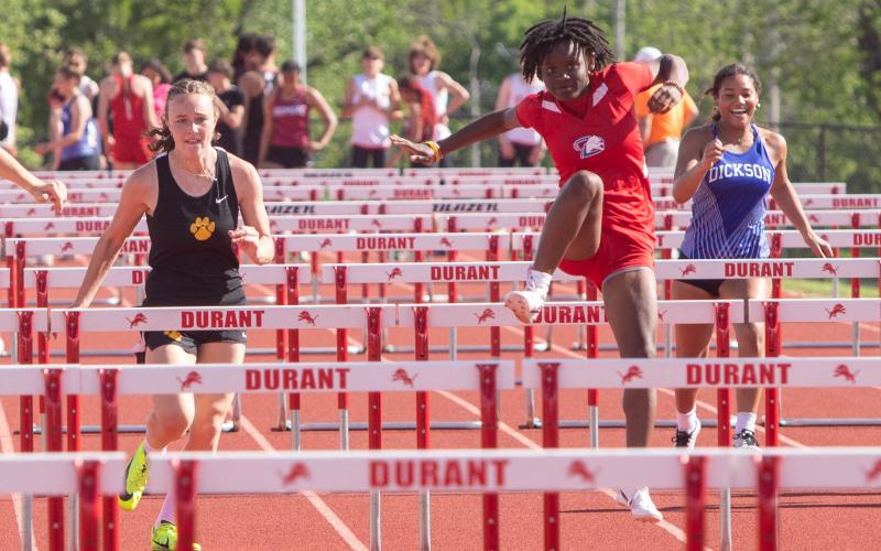 Lady Lion Iyana Wilson jumps over a hurdle at last week’s track meet. Matt Swearengin | Durant Democrat