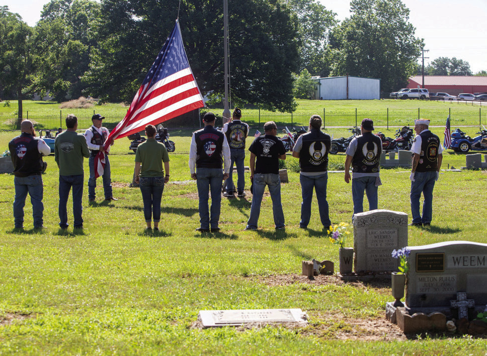 Motorcyclists raise the flag during a Memorial Day service Monday morning at Silo Restland Cemetery. Matt Swearengin | Durant Democrat