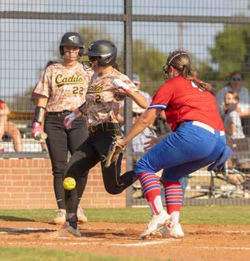 Caddo Lady Bruin Kiersyn Powell lands on home plate and also shown are Lady Bruin Kayden Prince and Lady Lion Emma Sherrer during a recent home game with the Durant Lady Lions.