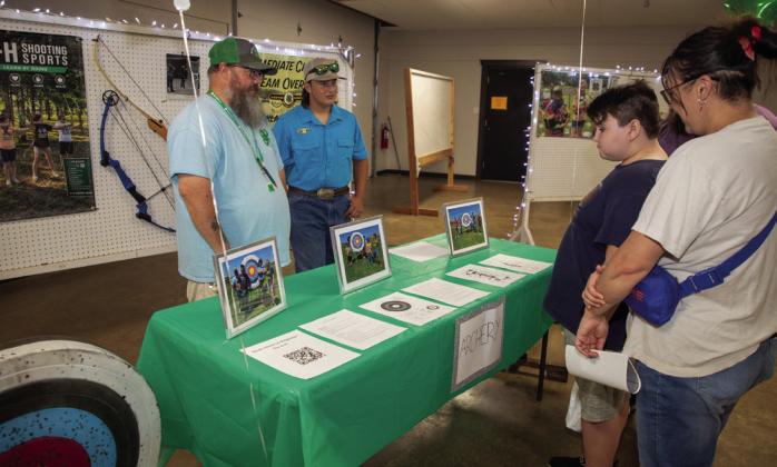 Patrick Goodwin, 4-H archery coach, and Michael Murphy, 4-H archery member, are shown during the Bryan County 4-H informational night at the Clay Jones Community Center. Matt Swearengin | Durant Democrat