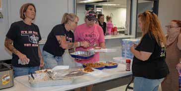 Okie Toy Run members Lisa Townsend, Lori Jo Reid and Teresa Kiersey serve fish at the Durant Elks Lodge to raise funds for school supplies. Matt Swearengin | Durant Democrat