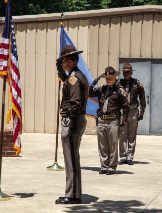 Members of the Oklahoma Highway Patrol Honor Guard salute after posting the colors during a memorial service Sunday afternoon at Boland Park in Caddo to remember the three troopers killed in the line of duty on May 26, 1978, with McAlester Prison escapees. Matt Swearengin | Durant Democrat