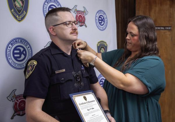 Kelsey Walker, Bokchito town clerk/court administrator, pins a sergeant insignia on Ryan Walker of the Bokchito Police Department. Walker was promoted last week and a ceremony was held at city hall. Matt Swearengin | Durant Democrat