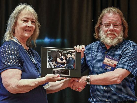 Durant Democrat editor Matt Swearengin received the Weekly Photo of the Year award sponsored by OGE Energy Corp. and Oklahoma Press Association The award was presented by OPA President Suzie Campbell during the Oklahoma Press Association convention in Norman. Photo provided | Oklahoma Press Association
