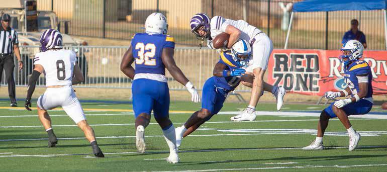 Southeastern football player Tony Hamilton lunges for a Ouachita Baptist player after he caught a pass. Also shown are Prince Dweh and Kole McKnight. Matt Swearengin | Durant Democrat