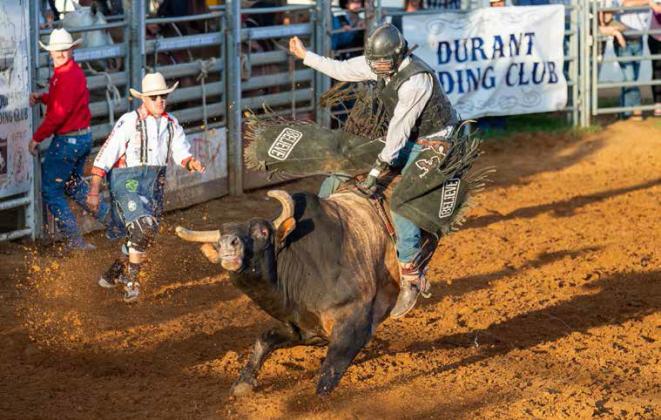 A bull rider is shown in the Durant PRCA Rodeo. LeAnn Polson |Barefoot Blonde Photographer