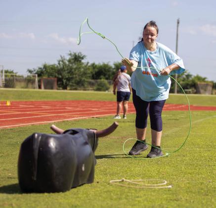 People First client Ashley Adair ropes a steer during the People First Industries Mike Morris Memorial Track &amp; Field Day. Matt Swearengin | Durant Democrat
