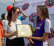 Durant Area Chamber of Commerce CEO Kara Byrd presents Durant Soccer Club board member Kayla Catiller with a certificate welcoming the club to the chamber of commerce. Matt Swearengin | Durant Democrat
