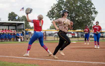 Durant Lady Lion Kenzie Trotter looks to catch the ball during a recent game with Caddo while Caddo Lady Bruin Ryan Uber runs to first base.
