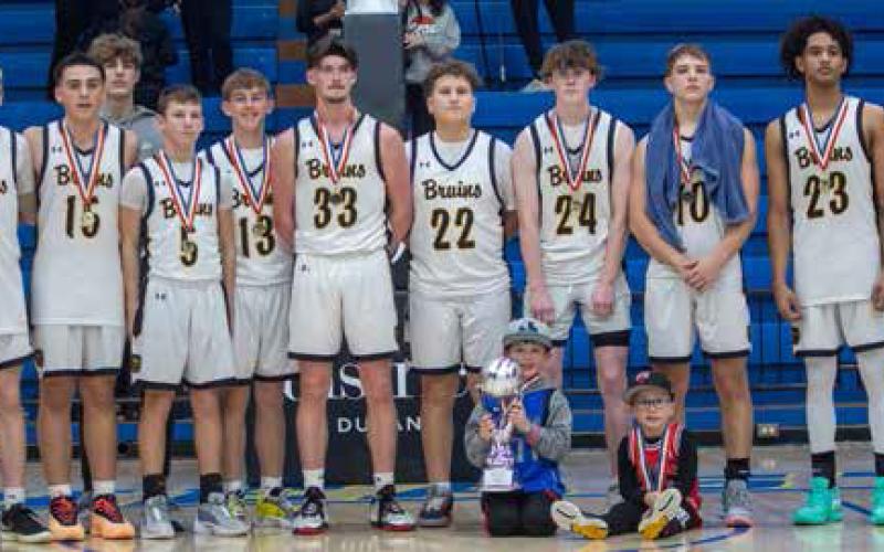 The Caddo Bruins pose after winning the Bryan County Basketball Tournament championship game Saturday night at Bloomer Sullivan Arena. The Bruins defeated the Rock Creek Mustangs 48-41.