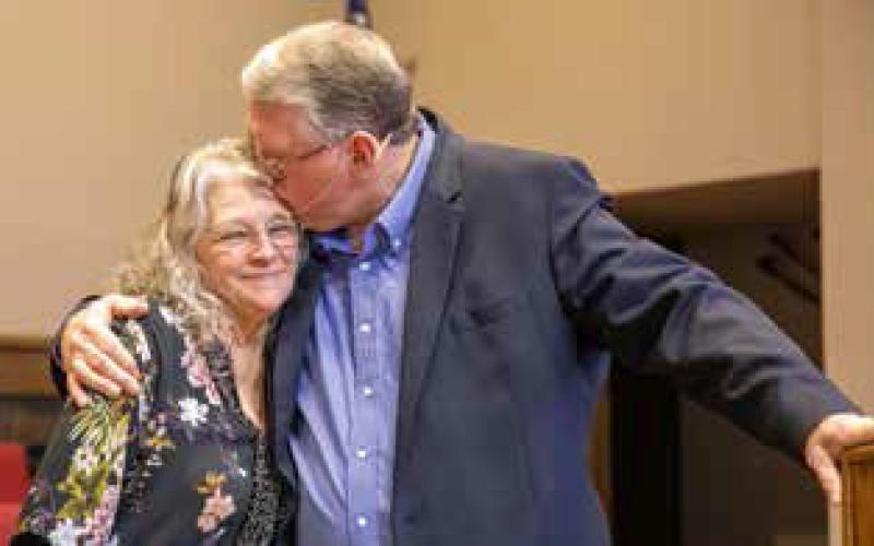 Brother Darel Bunch embraces his wife Cindy after his last sermon as pastor of Calvary Baptist Church. Matt Swearengin | Durant Democrat