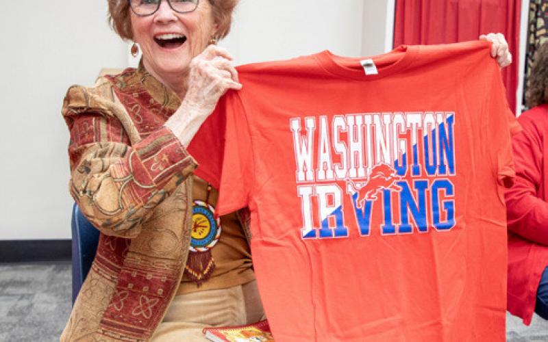 Dr. Melinda McClanahan reacts after she was given a Washington Irving Elementary School T-shirt. McClanahan attended WI in the 1940s.