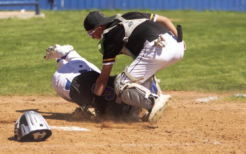 Rock Creek Mustang Matt Buchanan tries to make it to home plate in the game with the Caddo Bruins.
