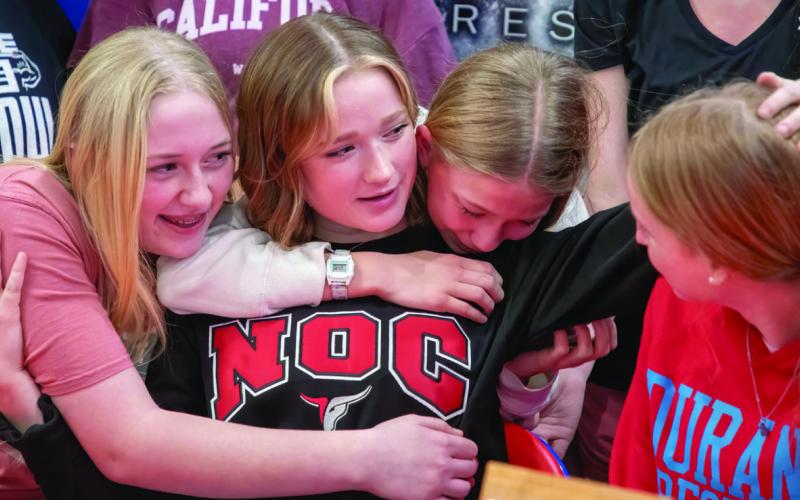 Durant wrestler Addison Polk, who signed to continue wrestling at Northern Oklahoma College, celebrates with Kenzie Trotter, Bailey Cross and Olivia Crossland.
