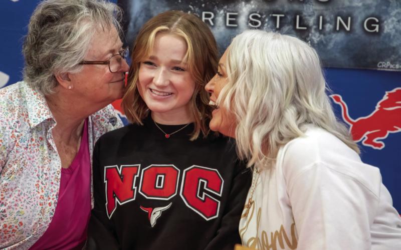 Durant Lady Lion wrestler Addison Polk, who became the first female athlete in school history to continue wresting in college, is shown with her grandmothers Bonnie Eastwood, left, and Pam Polk. Matt Swearengin | Durant Democrat