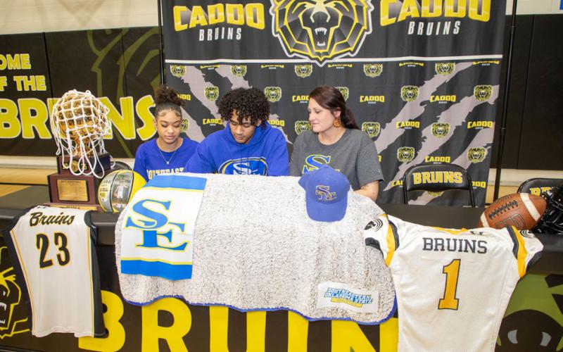Caddo Bruin D.J. Dill signed to play basketball with Southeastern. He is shown with his sister Ressa Dill and mother Marissa Dill. Matt Swearengin | Durant Democrat
