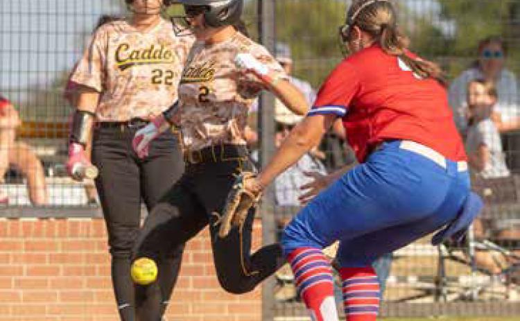 Caddo Lady Bruin Kiersyn Powell lands on home plate and also shown are Lady Bruin Kayden Prince and Lady Lion Emma Sherrer during a recent home game with the Durant Lady Lions.