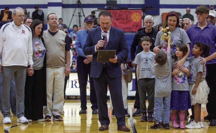 Durant Schools Superintendent Mark Moring reads a proclamation on Feb. 13 when the Durant High School Gym was dedicated as the Robinson Family Gymnasium. Durant Lady Lions head coach Will Robinson and his daughter Clara died in a Christmas Eve 2024 car accident. Matt Swearengin | Durant Democrat