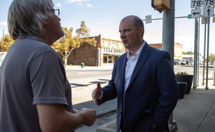 Oklahoma Attorney General candidate Jon Echols, right, visits with Mike Ridgway during a visit to Durant last week. Matt Swearengin | Durant Democrat