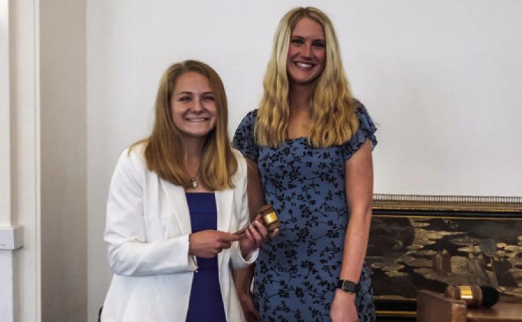 Incoming Southeastern Oklahoma State University student body president Sarah Coblentz (left) receives the gavel from outgoing student body president Addison McCortney. Dan Hoke | SE