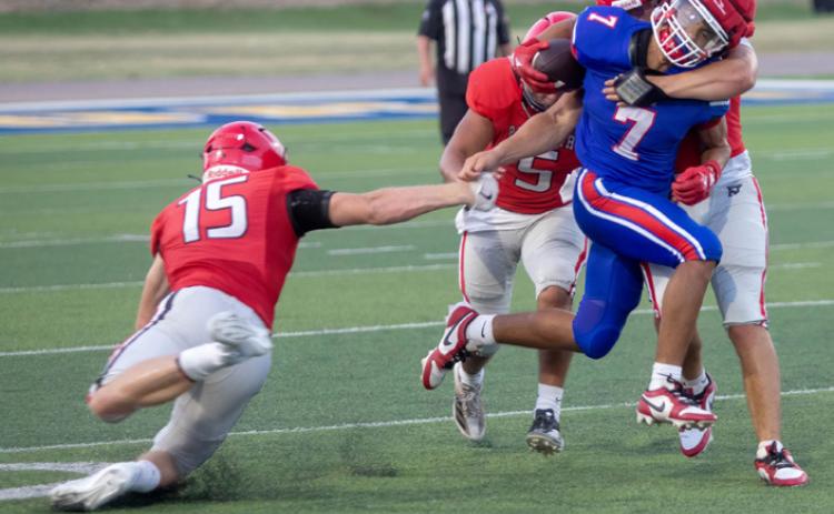 A Pauls Valley player grapples with Lion Joseph Flores during last week’s scrimmage at Paul Laird Field. Matt Swearengin | Durant Democrat