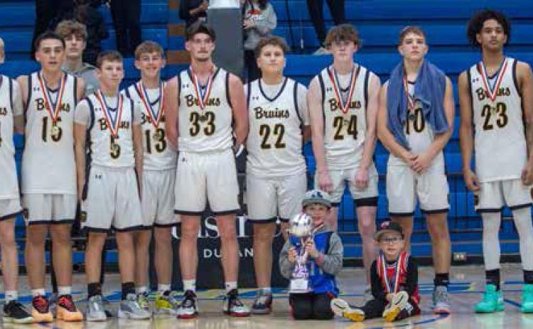 The Caddo Bruins pose after winning the Bryan County Basketball Tournament championship game Saturday night at Bloomer Sullivan Arena. The Bruins defeated the Rock Creek Mustangs 48-41.