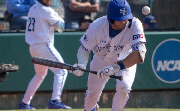 SE player Ryan Kirk hits the ball while JJ Bush is on deck.