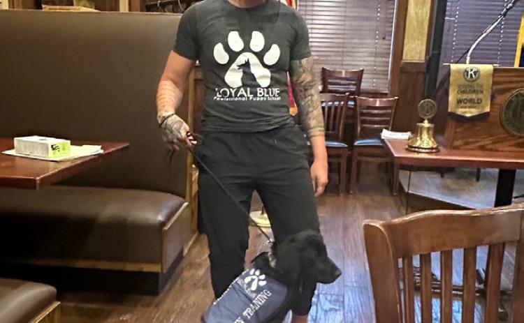 Coco, a black Labrador retriever puppy, was one of the visitors to the Kiwanis Club last month. She brought along her trainer, Sarah Hill. Coco is enrolled at Loyal Blue Pawfessional Obedience Training School. Photos provided