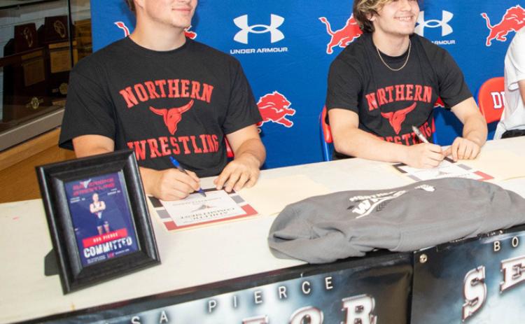 Durant High School seniors Asa Pierce and Bo St. Clair recently signed scholarships to wrestle at Northern Oklahoma College in Tonkawa. Matt Swearengin | Durant Democrat