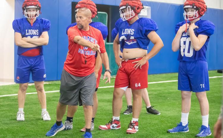 Durant Lions football defensive coordinator Mike Dills talks to players during spring practice. Matt Swearengin | Durant Democrat