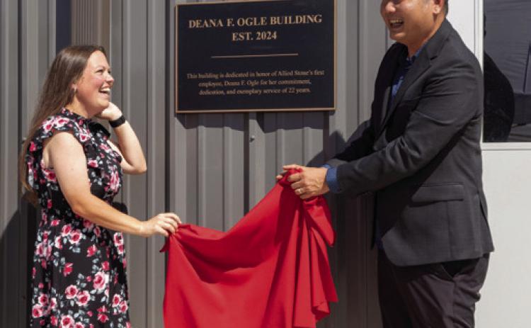 The sign for the Allied Stone Deana F. Ogle Building was unveiled during a ceremony last Friday to celebrate the company’s expansion. The late Ogle was Allied Stone’s first employee. Shown are Ogle’s granddaughter, Shelby Gardner, and Jerry Lim, Allied Group president. Matt Swearengin | Durant Democrat