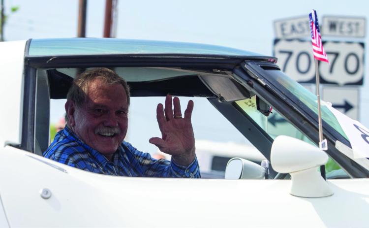 Michael “Happy” Folsom waves during the Bokchito Homecoming Parade Saturday morning.