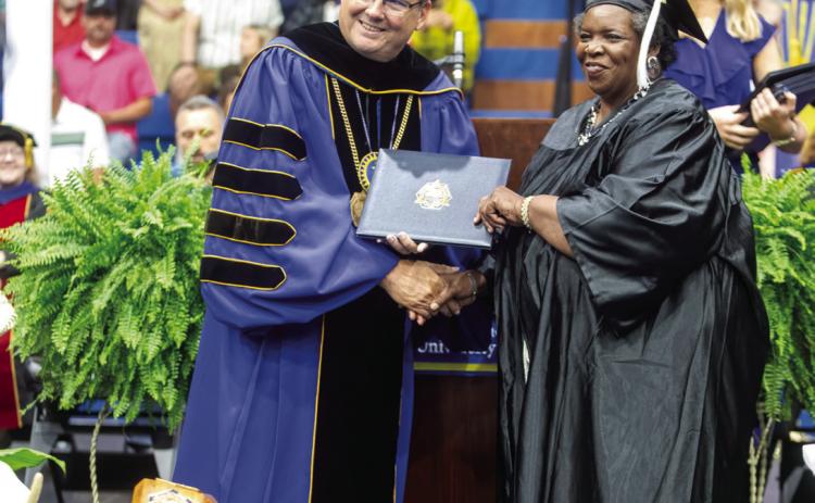 Southeastern Oklahoma State University President Thomas Newsom presents a degree during undergraduate commencement recently at Bloomer Sullivan Arena. Matt Swearengin | Durant Democrat