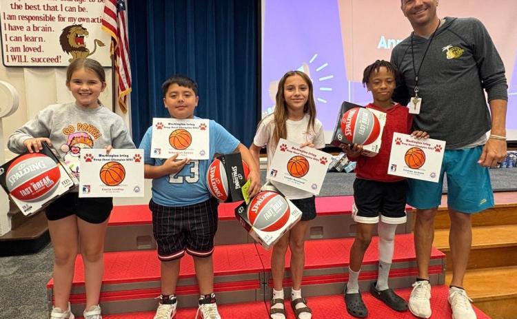 Washington Irving Hoop Shoot winners are (pictured left to right): Emrie Lindley (8-9 year old girls), Sebastian Gomez (8-9 year old boys), Landri Rowland (10-11 year old girls) and Tristian Jackson (10-- 11 year old boys). Also pictured is Washington Irving PE coach Tanner Dupree. Photo provided | WI