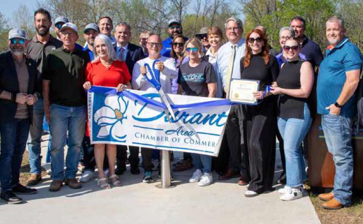 A ribbon was cut during the dedication ceremony of the Crooked Smile pedestrian bridge. The bridge is located off North First Avenue near the Southeastern Visual &amp; Performing Arts Center and it crosses Chuckwa Creek. Matt Swearengin | Durant Democrat