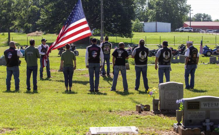 Motorcyclists raise the flag during a Memorial Day service Monday morning at Silo Restland Cemetery. Matt Swearengin | Durant Democrat