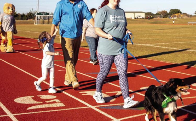 Matt Swearengin | Durant Democrat Ryan and Melissa Brewer walk with their daughter Addie and their dog Biscuit during the Breakthrough Type 1 Diabetes Walk Sunday at the Durant Multi-Sports Complex.