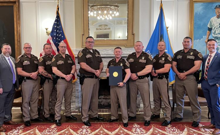 Rep. Cody Maynard and Sen. David Bullard are shown with Oklahoma Highway Patrol Trooper of the Year Jerrid Hobbie (center) and other troopers in the Senate Lounge. Photo provided