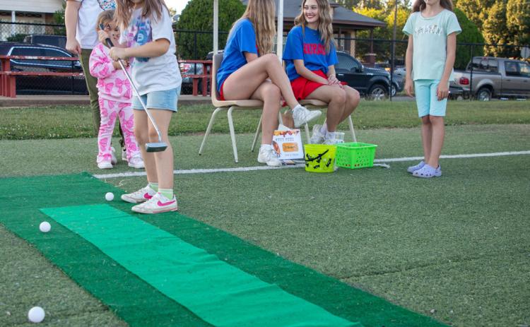 Matt Swearengin | Durant Democrat ABOVE: A girl hits a golf ball during the Washington Irving Elementary School Hot Dog Howdy event.