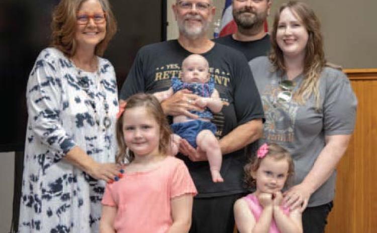Retiring Bryan County Assessor Mike Hull is shown with wife Aundrea, son Logan, his wife Annalie, and granddaughters Quinn, Micah and Rory during Hull’s retirement reception at the Bryan County Courthouse Annex. Matt Swearengin | Durant Democrat