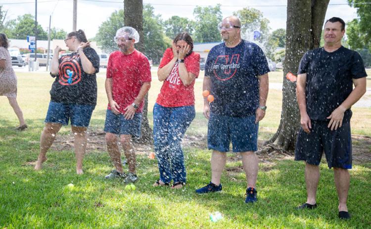 Matt Swearengin | Durant Democrat First United Bank loan officers got soaked with water balloons during a fundraiser Friday for school supplies. From left, Katie Jordan, Jimmy Fernandez, Hope Fenwick, Troy Taylor and Troy Frazier.