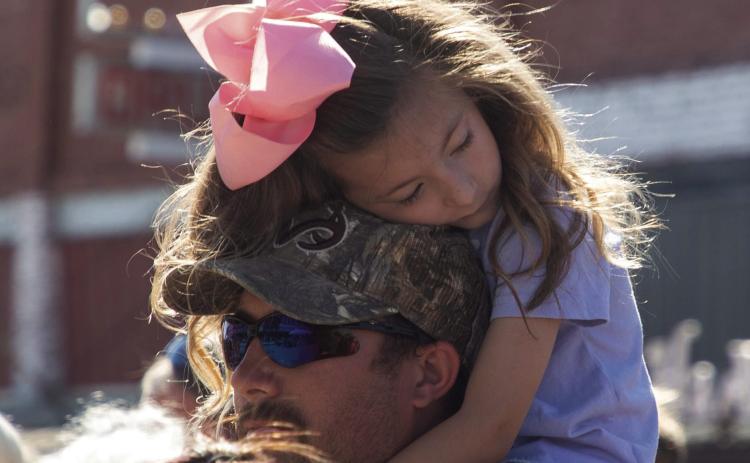 Hadley Fields sits on her father Bryson Fields’ shoulders and rests her head during Caddo Heritage Day Oct. 4. Matt Swearengin | Durant Democrat