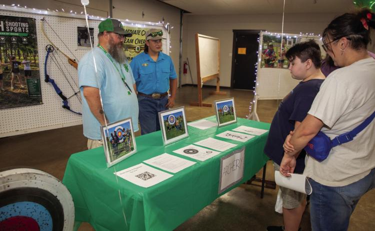 Patrick Goodwin, 4-H archery coach, and Michael Murphy, 4-H archery member, are shown during the Bryan County 4-H informational night at the Clay Jones Community Center. Matt Swearengin | Durant Democrat