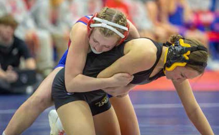 Lady Lion Addison Polk and Madill Lady Wildcat Andie Wallace wrestle during last week’s dual at Durant. Matt Swearengin | Durant Democrat
