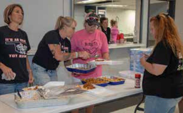 Okie Toy Run members Lisa Townsend, Lori Jo Reid and Teresa Kiersey serve fish at the Durant Elks Lodge to raise funds for school supplies. Matt Swearengin | Durant Democrat