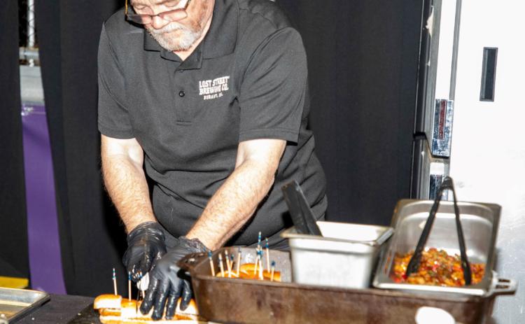 Scott Dewald of Lost Street Brewing Co. prepares bratwurst samples during the annual Taste of Durant at Choctaw Event Center.