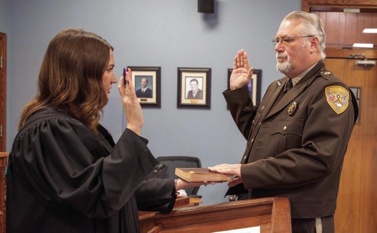 Bryan County Sheri_ Johnny Christian is sworn into his third term by Bryan County Associate District Judge Abby Rogers. Matt Swearengin | Durant Democrat